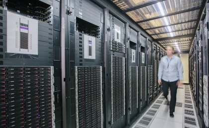 A man walks along a corridor in a data centre